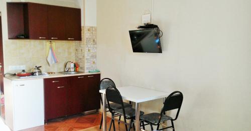 a kitchen with a table and chairs and a sink at "Gudauri Heart" Apartment in Gudauri