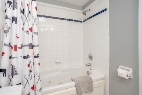 a white bathroom with a tub and a shower curtain at Blue Mountain (1 bedroom) Escape at North Creek Resort in Blue Mountains