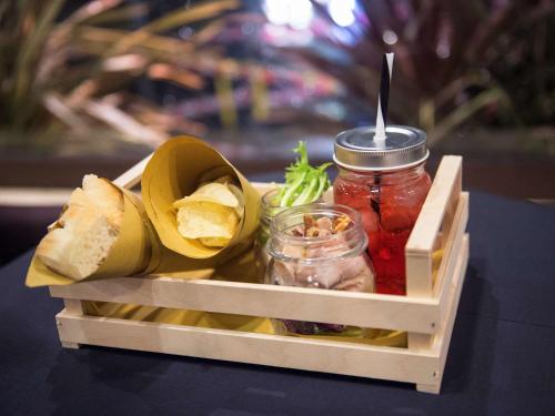 a wooden crate filled with jars of pickles and fruit at Mercure Roma Piazza Bologna in Rome