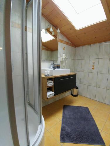 a large bathroom with a shower and a sink at Ferienhaus Bergblick in Fulpmes