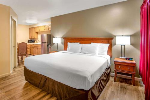 a bedroom with a large bed and a kitchen at Econo Lodge Inn & Suites Durango in Durango