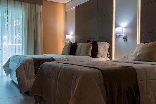 Ένα ή περισσότερα κρεβάτια σε δωμάτιο στο Hotel Los Alpes Cipreses