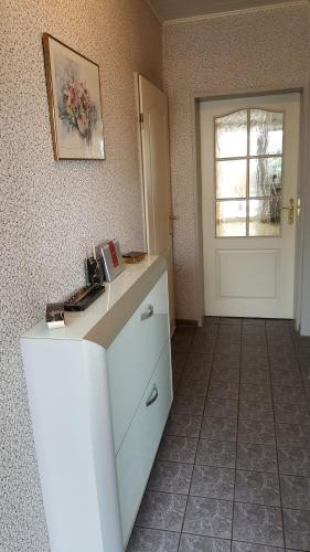 a room with a counter with a door and a window at Ferienhaus "Auberge Jolie" in Aachen