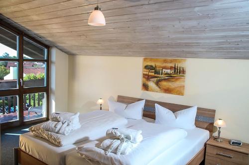 a bedroom with two beds with white pillows at Hotel Centurio in Bad Gögging