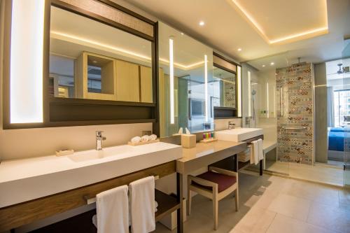 a bathroom with two sinks and a large mirror at Hyatt Zilara Cap Cana - Adults Only in Punta Cana