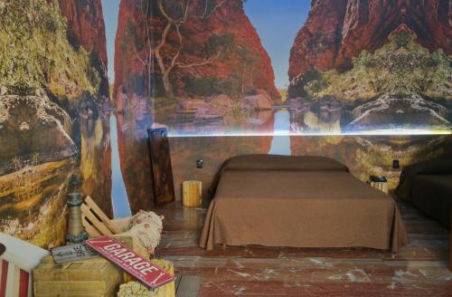 a room with a bed with a painting on the wall at Ahr Hotel Villa Alighieri in Stra