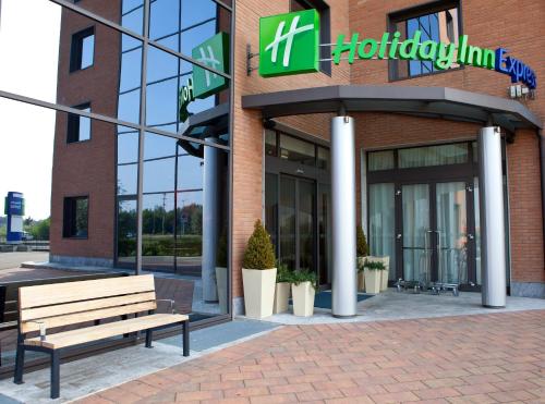 a building with a sign on the side of it at Holiday Inn Express Reggio Emilia, an IHG Hotel in Reggio Emilia