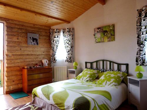 a bedroom with a bed and a wooden wall at Les dauphins de Mareuil in Mareuil-sur-Cher