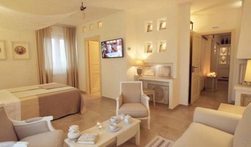 a hotel room with a bed and a living room at Le Nicchie Guest House in Lucera