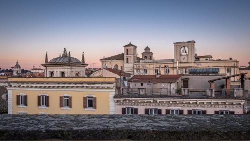a group of buildings with a clock tower on top at Antica Dimora Delle Cinque Lune in Rome