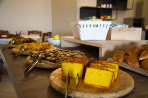 a table topped with plates of bread and cakes at Falcon Hotel in SantʼAgata Feltria