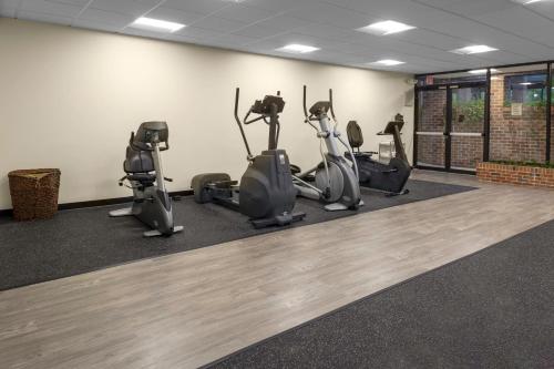 a gym with treadmills and exercise bikes in a room at William Tell Hotel MOD Collection by Sonesta in Countryside