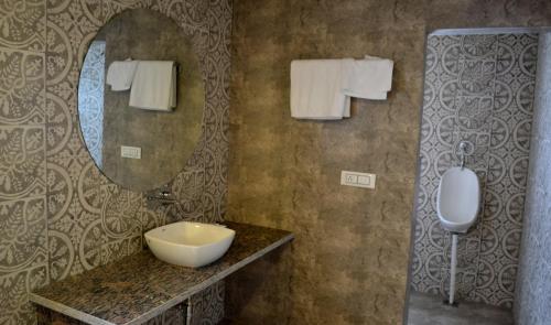 a bathroom with a sink and a mirror at Virat Resorts, Sariska Rajasthan in Bairāt