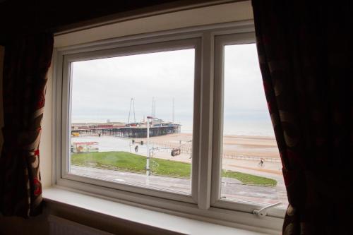a window with a view of the beach at Viking Hotel- Adults Only in Blackpool