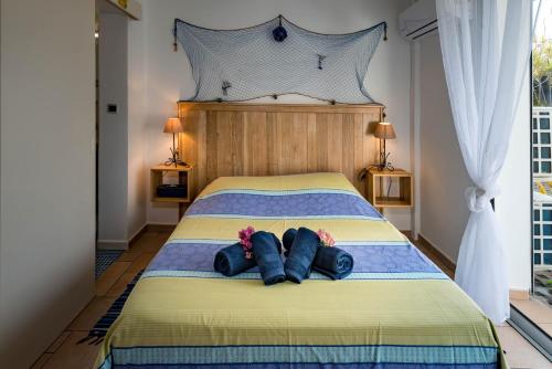 a bedroom with a bed with two people laying on it at T2B Lagon Austral "parenthèse australe" in Saint-Pierre
