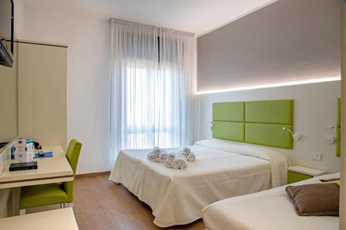 Postel nebo postele na pokoji v ubytování Hotel Bareta
