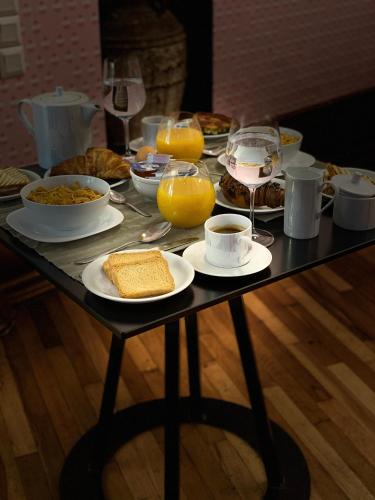 a table with breakfast foods and drinks on it at Step One | Luxury Suites right in the heart of Acropolis next to metro station in Athens