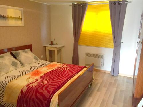 a bedroom with a bed and a large window at Chambres d'Hôtes Le Clos du Murier in Villefranche-de-Rouergue