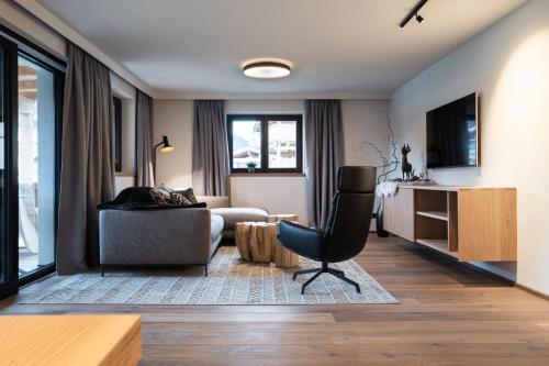a living room with a couch and a chair at KaiserMoments in Going