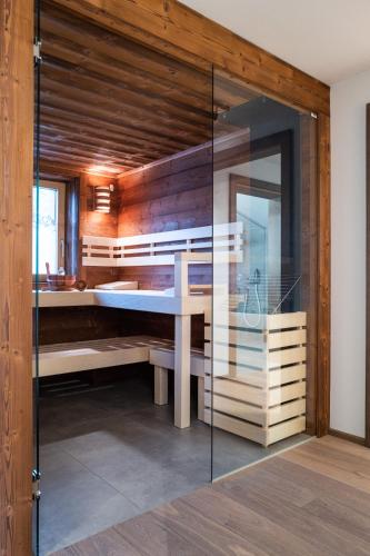 a bathroom with a tub and a glass wall at KaiserMoments in Going