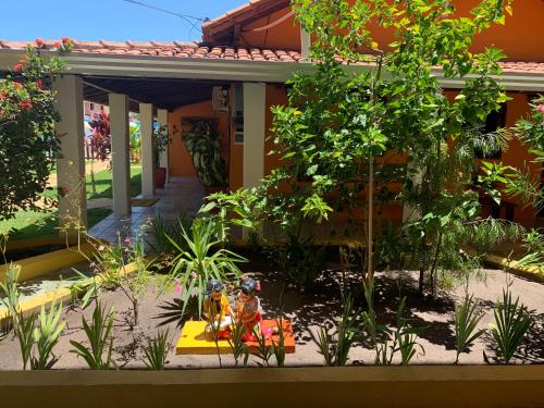 a garden in the front of a house at Pousada Paradise in Alcobaça