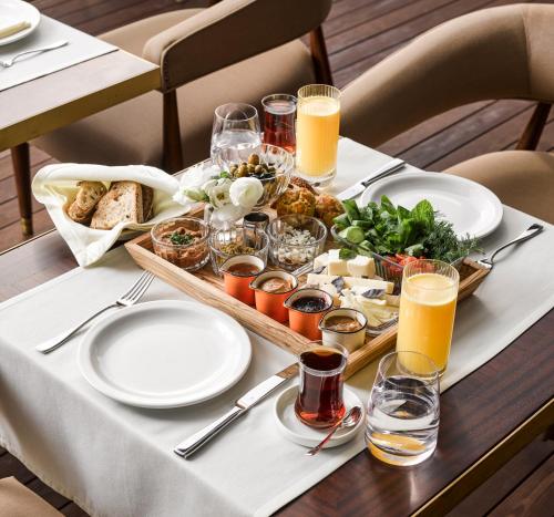a table with a tray of food and glasses of orange juice at Georges Hotel Galata in Istanbul