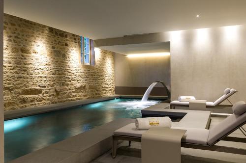 a swimming pool with two chairs and a swimming pool at Château de Bagnols in Bagnols