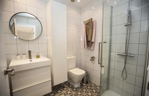 a bathroom with a toilet and a sink and a mirror at Villa Ana Maria - Townhouse in Alicante