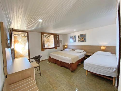 Een bed of bedden in een kamer bij Hotel Parque das Fontes