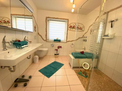 a bathroom with a shower and a sink and a toilet at FeWo Waldkauz in Berchtesgaden