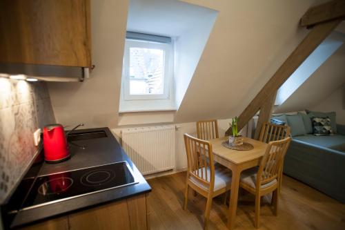 a small kitchen with a small table and a stove at Luxury Suites Riverside Residence by Rikas Hotels in Antwerp