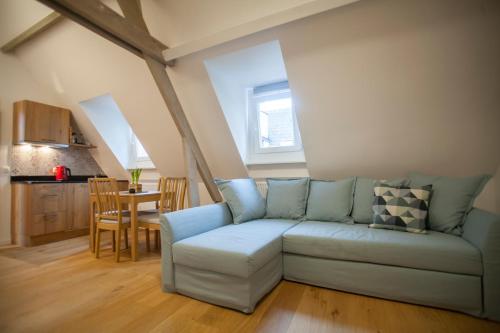 a living room with a couch and a table at Luxury Suites Riverside Residence by Rikas Hotels in Antwerp