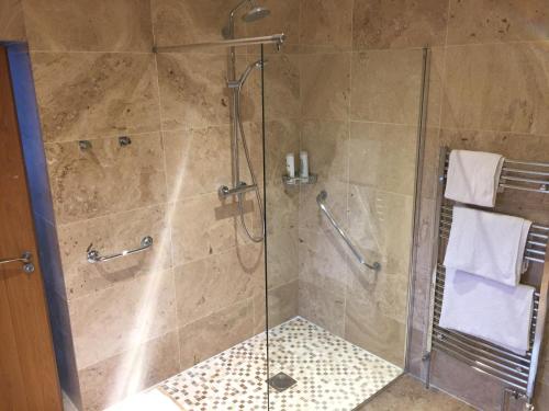 a bathroom with a shower with a glass door at Brackfield House Deal 49 in Killaloo