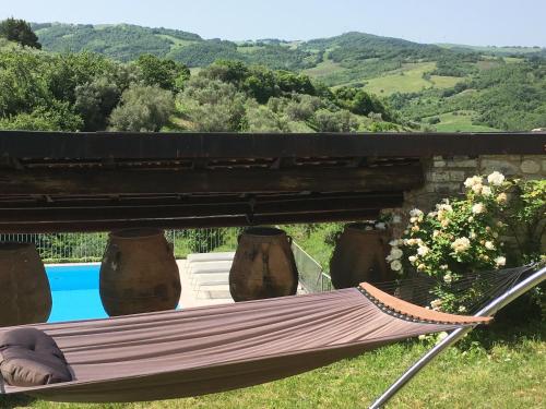 a hammock in the grass next to a pool at Oleandro 2 in Ripabottoni
