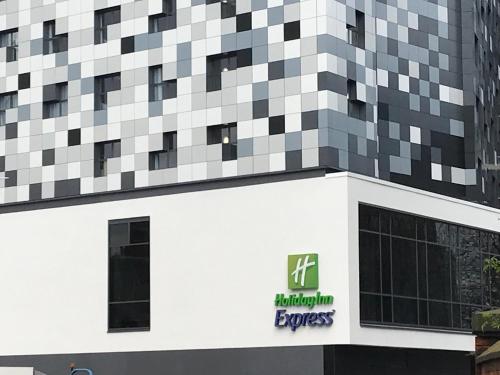 a large building with a sign on the side of it at Holiday Inn Express - Birmingham - City Centre, an IHG Hotel in Birmingham