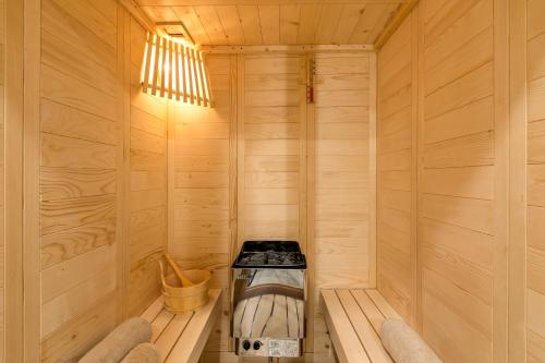 a wooden sauna with a stove in it at All Seasons Paradise in Khrisovítsion