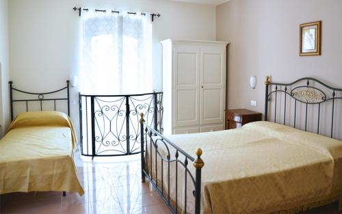 1 dormitorio con 2 camas y ventana en Affittacamere San Francesco, en Matera