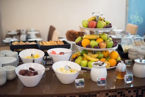 a buffet with bowls of fruit on a table at Vila Gale Serra da Estrela in Manteigas