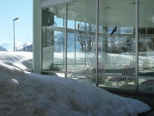 a pile of snow in front of a building at Hotel Regina Terme in Leukerbad