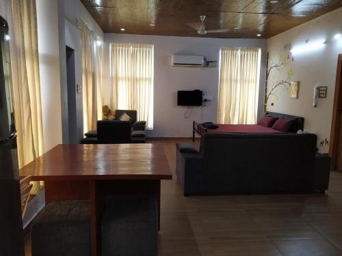 a living room with a couch and a table at Waves Beach House in Puducherry