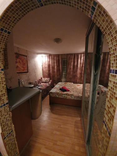 a small room with a bed and a sink at House Hotel Apartments 3 in Rivne