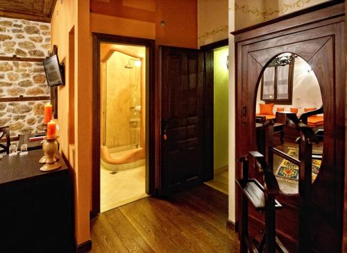 a hallway with a door leading to a bathroom at Orologopoulos Mansion Luxury Hotel in Kastoria