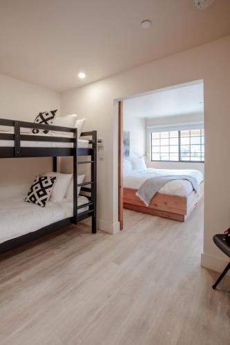 a bedroom with two bunk beds and a mirror at Best Friends Roadhouse and Mercantile in Kanab