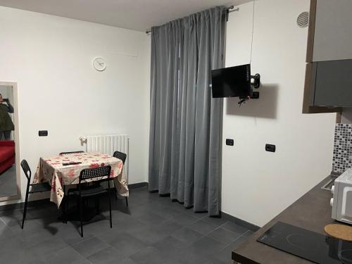 a room with a table and a television in a room at BICOCCA APPARTAMENTI in Milan