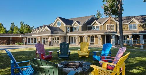 a group of chairs sitting in front of a house at Touchstone Resort in Bracebridge