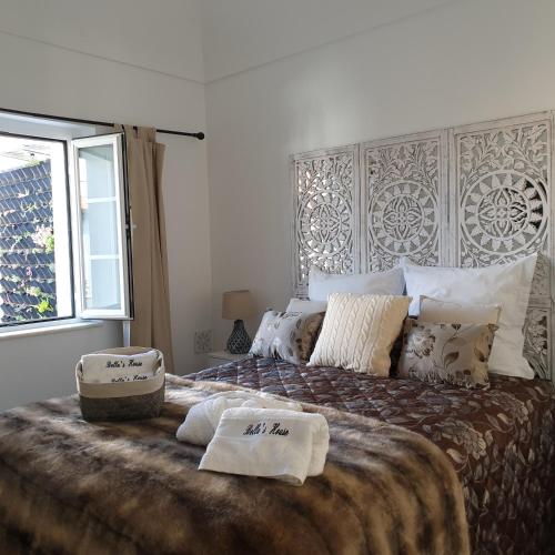 a bedroom with a large bed with two towels on it at Bella's House 4 com Piscina in Évora