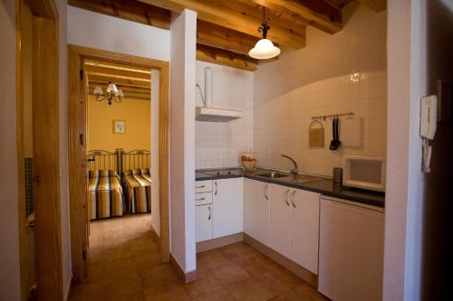 a kitchen with white cabinets and a sink at El Rincón de Uña in Uña