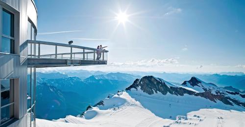 a person standing on a platform on top of a mountain at Apartment Leontina in Kaprun