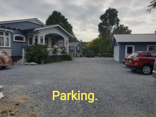 a driveway in front of a house with a car parked at Cabins on Tudor bed & breakfast in Motueka