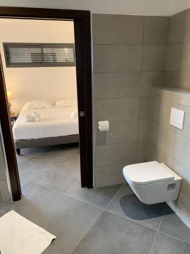 La salle de bains est pourvue de toilettes et d'un lit. dans l'établissement Résidence Les Jardins du Fort, à Porticcio